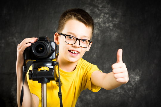 Teenage boy using big digital camera