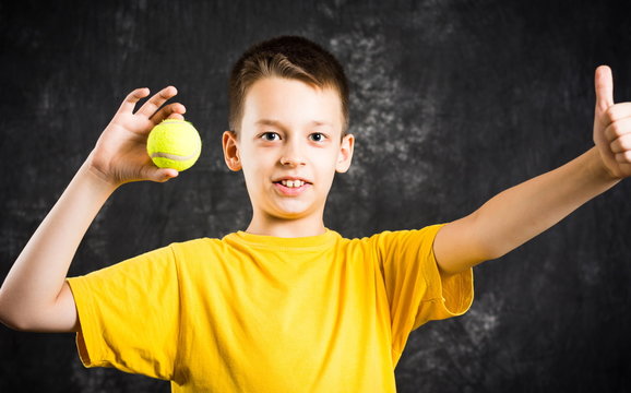 Happy Teenage Boy Holding A Tennis Ball