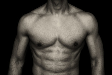 muscle young man on dark background - male body part
