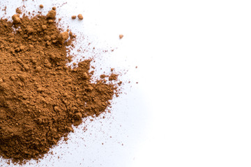 pile cocoa powder in a scoop isolated on white. heap of fresh of chocolate studio shot