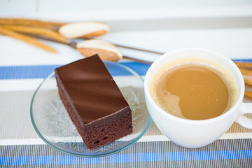 A cup of coffee and Chocolate cake show food background