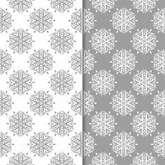 White and gray floral backgrounds. Set of seamless patterns