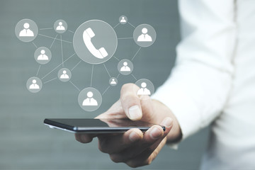 Hand holding smartphone with glowing mobile app icons