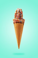 cone of ice cream with chocolate syrup and candy, on a blue background