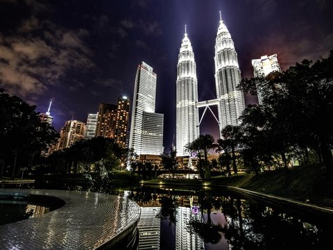 Low Angle View Of Illuminated Petronas Towers Against Sky At Night