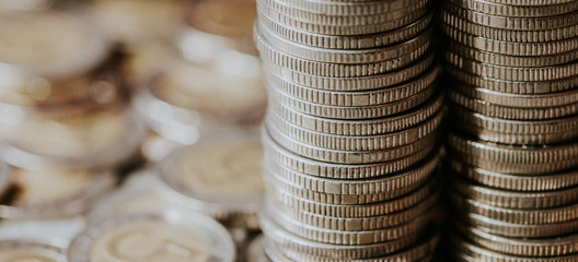 Stacked coins empty copy space business background. Polish five zlotych currency coins.