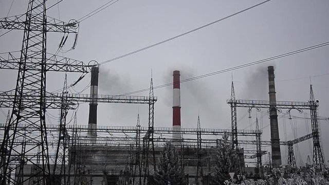 Power lines in the snow. Cogeneration plant in a strong blizzard