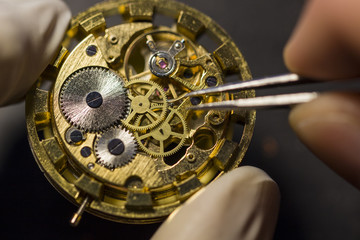 Watchmaker is repairing the mechanical watches in his workshop
