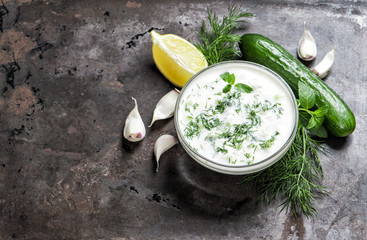 Tzatziki sauce herbs vegetables Food background