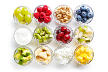 Food ingredients in glass bowls isolated on white, from above