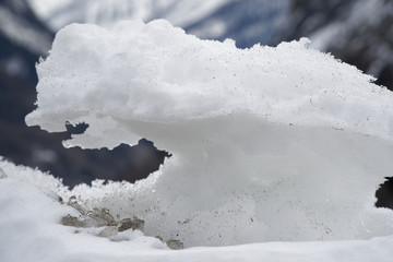 Snow Winter background, close-up of frosted ice lump on a snowing day with copy space