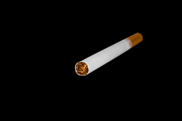 cigarette against a black background harm health