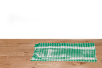 Empty wooden deck table with tablecloth for product montage. Free space for your text