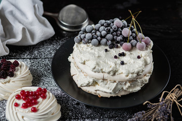 Pavlova cakes with cream and fresh summer berries - 192382008