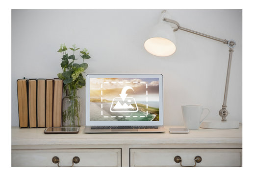 Laptop Mockup on Table with Books and Lamp