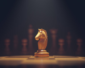 The knight in highlight. Pieces of chess game, image with shallow depth of field.