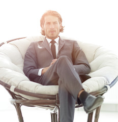 Fototapeta premium confident businessman sitting in a large comfortable chair.