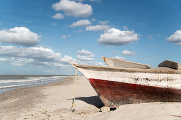 Obraz premium fisherman boat on the sand on a sunny beach. Guajira . Colombia.