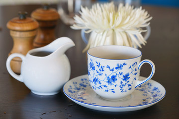 A china tea cup and saucer with a blue and white flower pattern