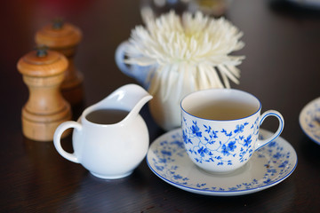 A china tea cup and saucer with a blue and white flower pattern