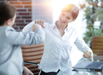 members of the business team giving each other a fist bump