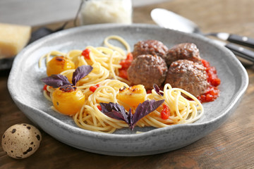 Delicious pasta with meat balls and tomato sauce on plate