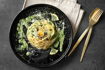 Delicious pasta with egg yolk and sauce on plate