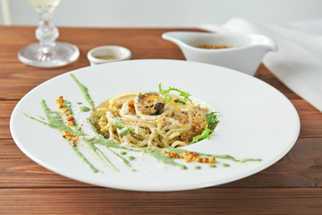 Delicious pasta with egg yolk and sauce on plate