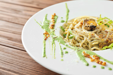 Delicious pasta with egg yolk and sauce on plate