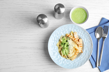 Delicious pasta with chicken on table