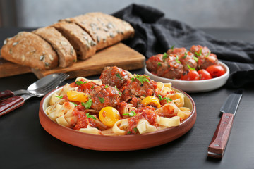 Delicious pasta with meat balls and tomato sauce on plate