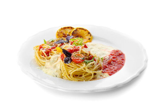 Delicious pasta with tomato sauce and vegetables on plate against white background