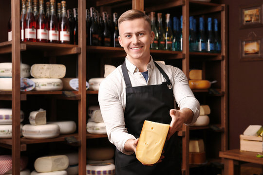 Business owner with cheese in his store