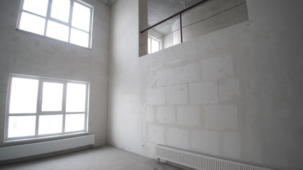 Fototapeta na wymiar Renovation interior. Clip. Blank white wall with window and concrete floor.