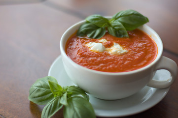 Creamy tomato soup with mozzarella and basil