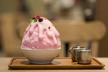 Kakigori Starberry or Starberry Korean Shave Ice Patbingsu or Bingsu Frozen dessert on wooden table in cafe shop