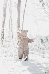 child in the forest in the snow	