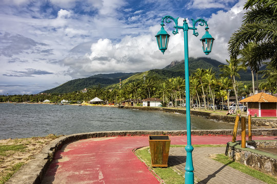 Bicycle lane by the sea in Ilhabela Pereque beach at sunset - Sao Paulo, Brazil