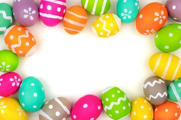 Colorful Easter egg frame isolated on a white background. Top view with copy space.