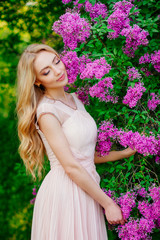 Fototapeta premium young beautiful woman in spring, beautiful blonde girl, charming in spring garden in dress
