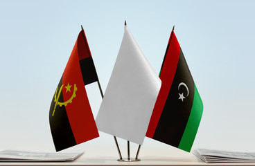 Flags of Angola and Libya with a white flag in the middle