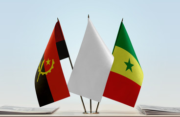 Flags of Angola and Senegal with a white flag in the middle