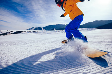 one snowboarder snowboarding in winter mountains