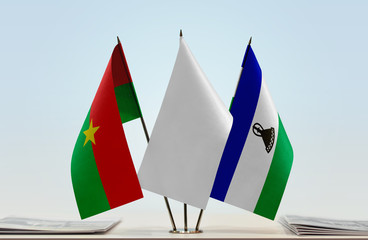 Flags of Burkina Faso and Lesotho with a white flag in the middle