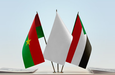 Flags of Burkina Faso and Sudan with a white flag in the middle