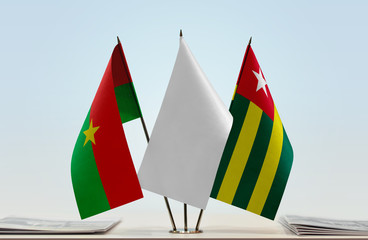 Flags of Burkina Faso and Togo with a white flag in the middle