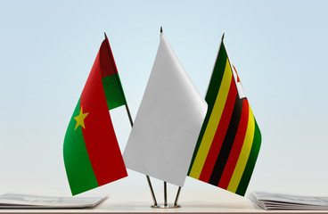 Flags of Burkina Faso and Zimbabwe with a white flag in the middle