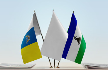 Flags of Canary Islands and Lesotho with a white flag in the middle