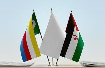 Flags of Comoros and Sahrawi Arab Democratic Republic with a white flag in the middle