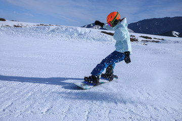 one snowboarder snowboarding in winter mountains